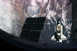 View of the STS-76 orbiter Atlantis moving away from the Mir space station 